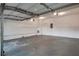 This spacious, attached garage features bright lighting, a coated floor, and built-in shelving at 2428 Harmony Ridge Ct, Lithonia, GA 30058