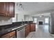 Modern kitchen features dark granite countertops, stainless steel appliances, and an open view to the living room at 2428 Harmony Ridge Ct, Lithonia, GA 30058
