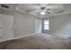 This main bedroom has carpet, a tray ceiling with fan, and closets at 2428 Harmony Ridge Ct, Lithonia, GA 30058