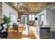 Open-concept living room with exposed brick, hardwood floors, and modern industrial-style ceilings and a kitchen at 3180 Mathieson Drive # 703, Atlanta, GA 30305