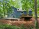 Rear exterior of the blue house featuring a deck and a gravel patio area at 4990 Turtle Rock Drive Dr, Marietta, GA 30066