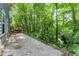 Backyard with a gravel patio, wooden retaining wall and a view of the wooden deck at 4990 Turtle Rock Drive Dr, Marietta, GA 30066
