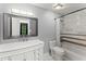 Modern bathroom featuring a marble vanity and a shower-tub combo with decorative tile accents at 4990 Turtle Rock Drive Dr, Marietta, GA 30066