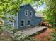 Back exterior of the blue home showcasing windows, doors, and outdoor living space at 4990 Turtle Rock Drive Dr, Marietta, GA 30066