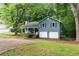 Charming split-level home with blue siding, a two-car garage, and a welcoming front yard at 4990 Turtle Rock Drive Dr, Marietta, GA 30066
