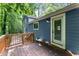 Rear exterior view of the home featuring a deck, blue siding, and a door leading to the outside at 4990 Turtle Rock Drive Dr, Marietta, GA 30066