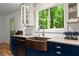 Close-up on a farmhouse sink and granite countertops in a modern kitchen setting at 4990 Turtle Rock Drive Dr, Marietta, GA 30066