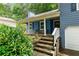 Close-up view of the cozy covered porch with seating and manicured landscaping at 4990 Turtle Rock Drive Dr, Marietta, GA 30066