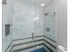 Glass walk-in shower with decorative tile and a built-in shelf at 4990 Turtle Rock Drive Dr, Marietta, GA 30066
