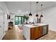 Open kitchen with an island bar, seamlessly connecting to the living space and balcony views at 112 Rogers Street Ne # 503, Atlanta, GA 30317