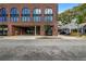 Building exterior featuring parking garage entry, brick facade, and convenient street access at 112 Rogers Street Ne # 503, Atlanta, GA 30317