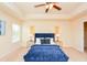 Spacious bedroom with tray ceilings, bedside lamps, and a window for natural light at 2010 Shortleaf Rd, Fairburn, GA 30213