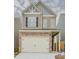 Charming two-story home features a brick and siding facade, and an attached two-car garage at 2010 Shortleaf Rd, Fairburn, GA 30213