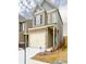 Charming two-story home features a brick and siding facade, and an attached two-car garage at 2010 Shortleaf Rd, Fairburn, GA 30213