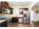 Well-equipped kitchen with stainless steel appliances, dark cabinetry, and laminate countertops at 2010 Shortleaf Rd, Fairburn, GA 30213