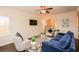 Bright living room features a ceiling fan, and comfortable seating with large windows at 2010 Shortleaf Rd, Fairburn, GA 30213