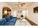 Open concept living room next to kitchen, has a ceiling fan, and comfortable seating at 2010 Shortleaf Rd, Fairburn, GA 30213