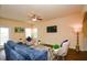 Bright living room features a ceiling fan, and comfortable seating with large windows at 2010 Shortleaf Rd, Fairburn, GA 30213