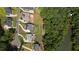 Property featuring a spacious lawn and picturesque lake access, complemented by surrounding trees at 4445 Pebble Rock Dr, Cumming, GA 30041