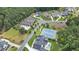 Aerial view of the community including tennis courts, a pool, clubhouse and lush landscaping at 4445 Pebble Rock Dr, Cumming, GA 30041