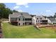 Expansive backyard featuring lush green lawn, a deck, and outdoor living, perfect for relaxation at 4445 Pebble Rock Dr, Cumming, GA 30041