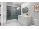 Modern bathroom featuring a walk-in shower, vanity with drawers and a stylish oval mirror at 4445 Pebble Rock Dr, Cumming, GA 30041
