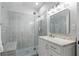 Bathroom featuring glass shower, grey backsplash tiles and a single vanity at 4445 Pebble Rock Dr, Cumming, GA 30041