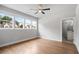 Bright bedroom with hardwood floors, large windows, ceiling fan, and ensuite bath at 4445 Pebble Rock Dr, Cumming, GA 30041