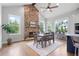 Elegant dining room with stone fireplace, hardwood floors, natural light and modern furnishings at 4445 Pebble Rock Dr, Cumming, GA 30041