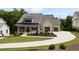 Stunning exterior view featuring a two-story home, well-manicured lawn and beautiful, winding concrete driveway at 4445 Pebble Rock Dr, Cumming, GA 30041