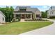 Charming two-story home with a landscaped yard, covered porch, and classic appeal at 4445 Pebble Rock Dr, Cumming, GA 30041