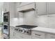 Modern kitchen featuring stainless steel appliances, white countertops, and sleek cabinetry at 4445 Pebble Rock Dr, Cumming, GA 30041