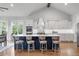 Bright, open kitchen featuring a large navy island, white cabinetry, and stainless steel appliances at 4445 Pebble Rock Dr, Cumming, GA 30041