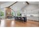 Expansive open-concept kitchen and dining area featuring a large island and stone fireplace at 4445 Pebble Rock Dr, Cumming, GA 30041