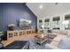 Spacious living room with high ceilings, modern decor, large windows, and hardwood floors at 4445 Pebble Rock Dr, Cumming, GA 30041