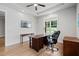 Spacious home office featuring hardwood floors, natural light, and stylish furniture at 4445 Pebble Rock Dr, Cumming, GA 30041