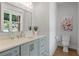 Charming powder room featuring a stylish vanity, floral art, and natural light at 4445 Pebble Rock Dr, Cumming, GA 30041