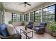 Cozy sunroom with comfortable seating, natural light, and views of the surrounding greenery at 4445 Pebble Rock Dr, Cumming, GA 30041