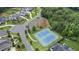 Aerial view of the community's tennis courts surrounded by mature trees and manicured lawns at 4445 Pebble Rock Dr, Cumming, GA 30041