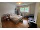 Bedroom with a cozy bed, window with curtains, and organized storage shelves at 713 Pine Chase Ct, Lawrenceville, GA 30043