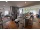 Open concept kitchen with an island featuring bar seating, wood floors, and ample natural light at 713 Pine Chase Ct, Lawrenceville, GA 30043