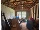 Unfinished living room with exposed beams, a door and window bringing in natural light, ready to be customized at 713 Pine Chase Ct, Lawrenceville, GA 30043