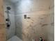 Tiled shower with a rainfall showerhead and built-in shelving for toiletries, offering a luxurious bathing experience at 713 Pine Chase Ct, Lawrenceville, GA 30043