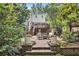 Beautiful backyard featuring a brick patio, deck, and lush landscaping, perfect for outdoor enjoyment at 1718 Ridgewood Ne Dr, Atlanta, GA 30307