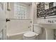 Bathroom with a tiled tub and pedestal sink at 1718 Ridgewood Ne Dr, Atlanta, GA 30307