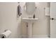 A cozy bathroom featuring a pedestal sink with a mirror, and a towel rack at 1718 Ridgewood Ne Dr, Atlanta, GA 30307