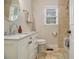 Charming bathroom featuring a white vanity with marble top, tile accents, and natural light from window at 1718 Ridgewood Ne Dr, Atlanta, GA 30307