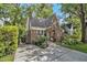 Charming brick home with a well-maintained lawn, mature trees, and a long driveway at 1718 Ridgewood Ne Dr, Atlanta, GA 30307