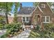 Inviting brick home featuring a cozy front porch with chairs and manicured greenery at 1718 Ridgewood Ne Dr, Atlanta, GA 30307