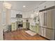 Stylish kitchen featuring stainless steel appliances, farmhouse sink, and two-tone cabinets at 1718 Ridgewood Ne Dr, Atlanta, GA 30307
